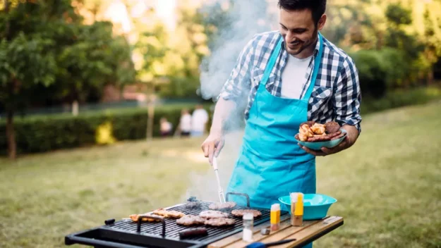 Support worker barbecuing food