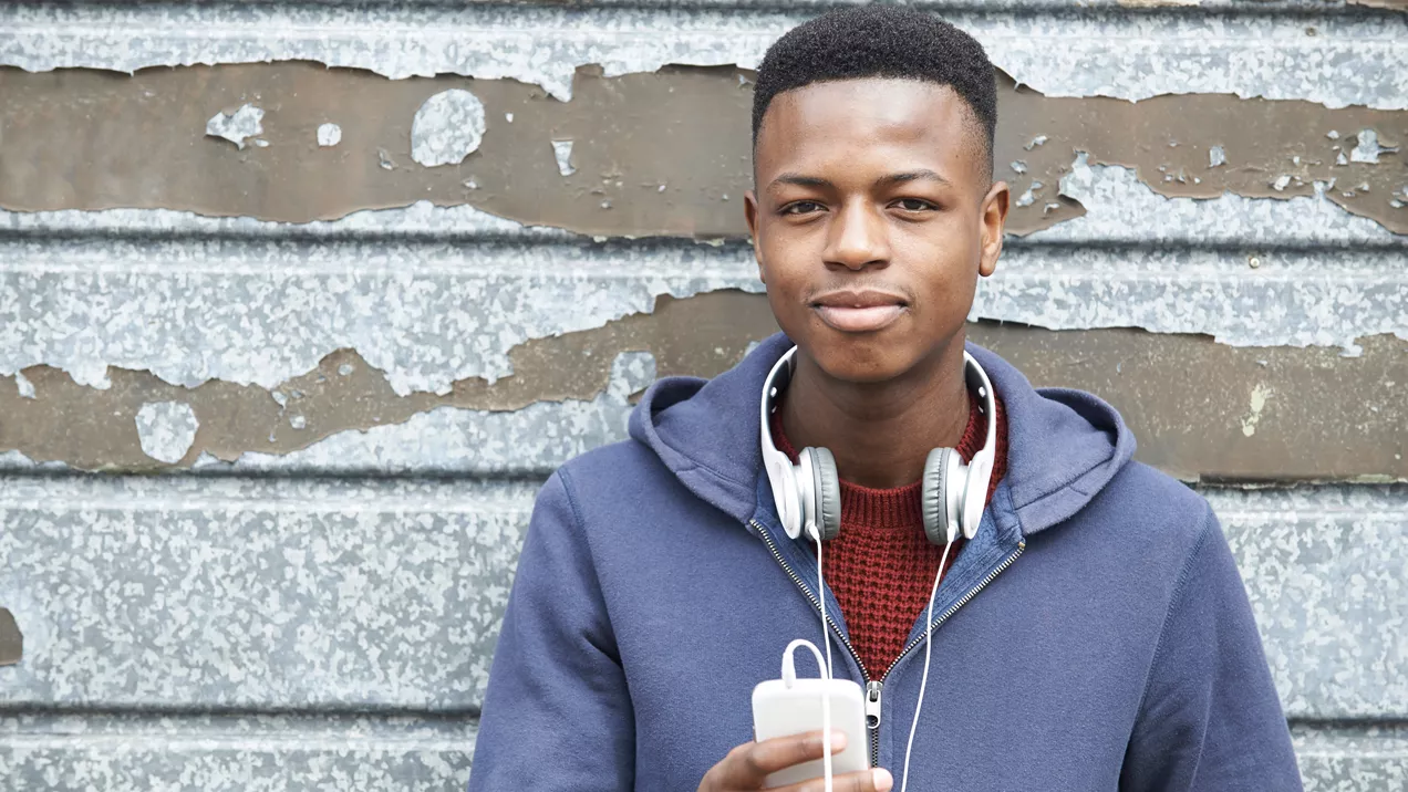 Young person listening to music on their phone